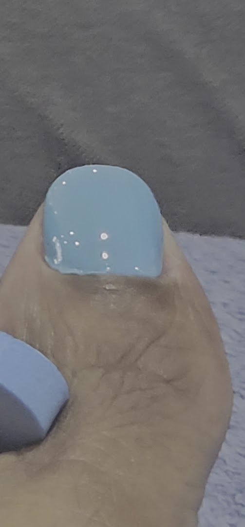 Nail technicians work on manicures and pedicures.